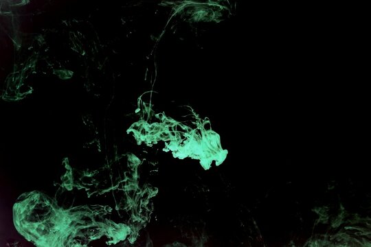 Abstract green or light green watercolor spread or stain on black background,Color Abstract,Green fluorescent