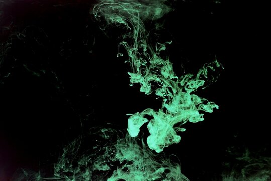 Abstract green or light green watercolor spread or stain on black background,Color Abstract,Green fluorescent
