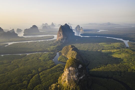 Aerial view, mangrove forest with meandering river and high karst rocks during sunrise, Ao Phang-Nga National Park, Phang-Nga Province, Thailand