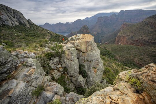 Young man on a rock, view of Blyde River Canyon with Mesa mountains, Upper Viewpoint, canyon landscape, Panorama Route, Mpumalanga, South Africa