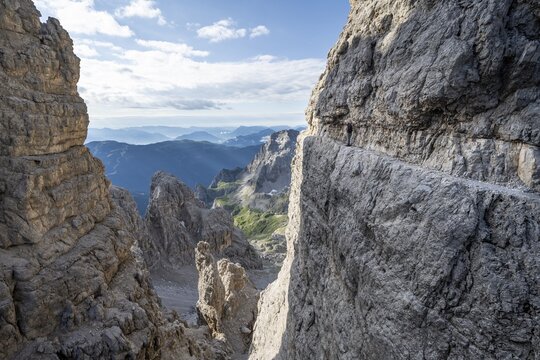 View from the Bocca degli Armi gap, mountaineers on a rock band on the Via Ferrata Bocciere Centrale via ferrata, Brenta Mountains, Brenta-Adamello Natural Park, Trentino, Italy