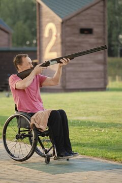 An old man in a wheelchair trains in a shooting range, aiming with precision and focus