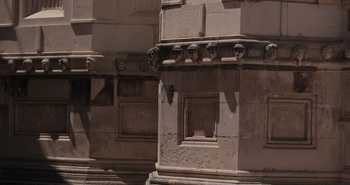 A stone frieze of carved human heads decorates the exterior of St James Cathedral in Sibenik Croatia.
