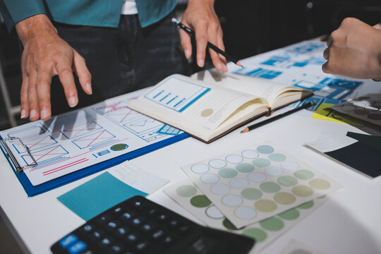 UI designer and UX developer brainstorm idea to design the application appearance in the early stage. Creative digital development agency. UX UI concept