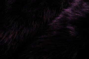 Fototapeta premium A detailed close up of dark purple luxurious fluffy faux fur textile surface background pattern
