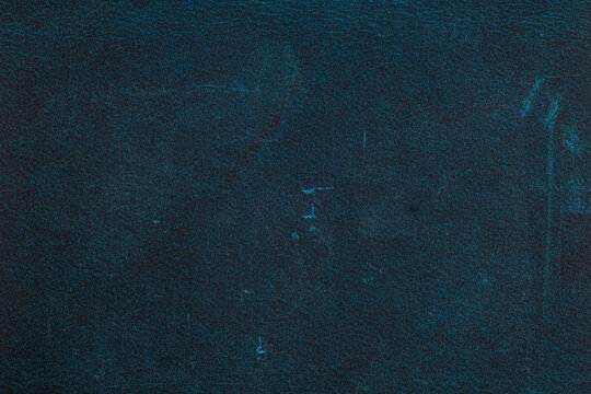 Dark blue leather surface with subtle texture and visible wear marks for backgrounds