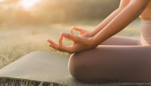 Close Up of Female Hands Meditating During Sunrise Yoga