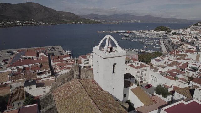 Aerial Drone Orbiting the Bell Tower of Historic Church in Port de la Selva, Costa Brava, Spain