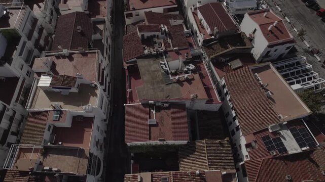 Aerial Drone Lateral Tracking Shot Looking Down at Rooftops in Port de la Selva, Costa Brava, Spain