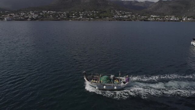 Aerial Drone Lateral Follow Shot Tracking Fishing Boat from the Side, Port de la Selva, Costa Brava, Spain