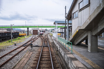 Fototapeta premium Railway station platform with curved tracks and train Japan