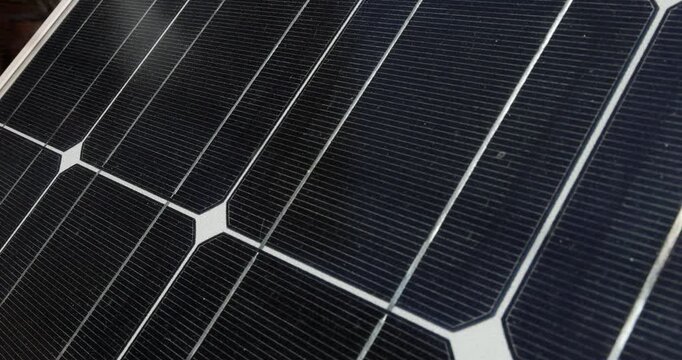 Detailed zoom view of a blue solar panel structure absorbing bright sun light rays for ecological green electricity generation