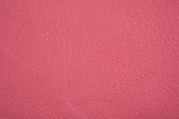 Fototapeta premium Pink leather material with subtle texture and grain detail
