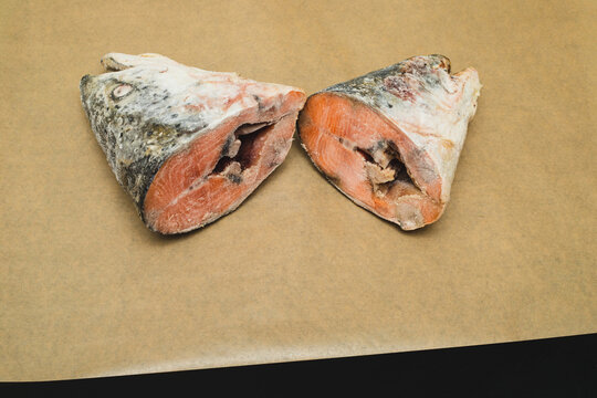 Budget friendly salmon heads frozen for later use in fish soup, budget meal prep allows buying whole fish or just cheap cuts, budget conscious cook never wastes edible parts like head and bones.