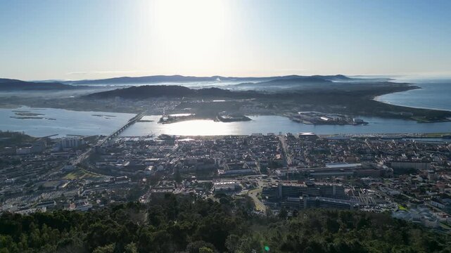 Aerial view over Viana do Castelo and Cabedelo at sunrise, featuring soft morning mist, golden light, coastal scenery, and a peaceful atmosphere.