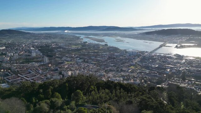 Aerial view over the Lima River and Viana do Castelo on a clear cold sunny day, showcasing the city, water reflections, and crisp winter atmosphere.