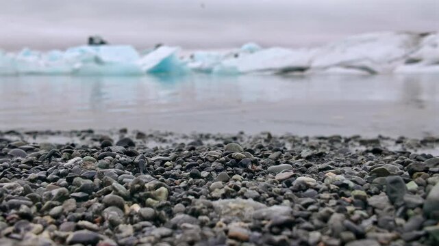 Majestic view of the Jokulsarlon glacier lagoon in Iceland. Scenic landscape with black volcanic pebbles and icebergs from the glacier