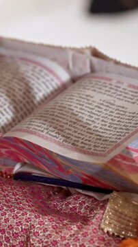 Vertical Shot of a Sikh Priest Reading Gurbani from the Guru Granth Sahib