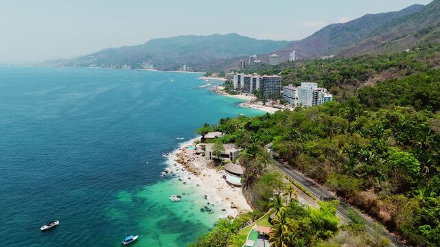 Scenic aerial footage of paredon beach in puerto vallarta, mexico, with turquoise water and resorts
