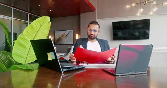 Businessman reviewing documents at modern office desk