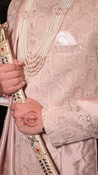 Vertical Closeup Revealing shot of Sikh Groom Standing with Kirpan For Wedding