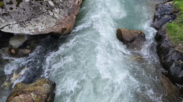 high angle view of turbulent mountain stream flowing over dark mossy rocks, powerful river current, wild nature, serene background, Mestia, Svaneti, Georgia