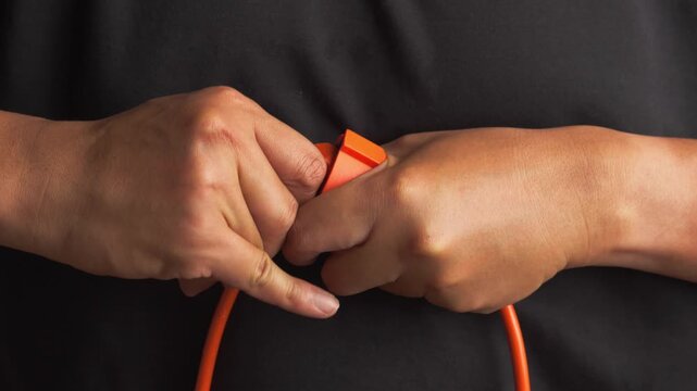 man's hand removing an electric plug from a power socket