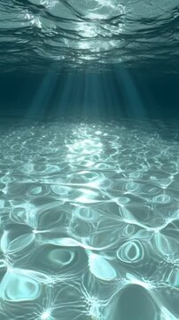 Sunlight penetrating clear ocean water creating shimmering patterns on sandy sea floor.