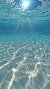 Sunlight penetrating clear ocean water with visible sandy seabed and underwater rays.