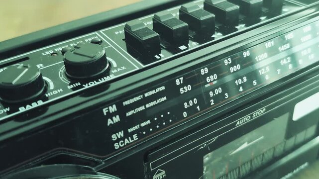 Old tape recorder from the eighties plays a cassette tape with sound and music