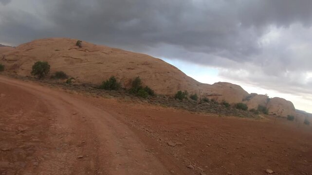Cinematic off-road travel footage around Moab with sandstone cliffs and iconic Southwest landscapes
