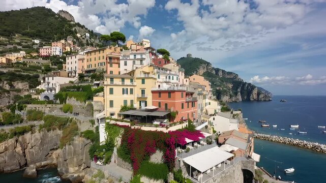 Explore cliffside homes in a coastal village with boats in the harbor during a sunny day