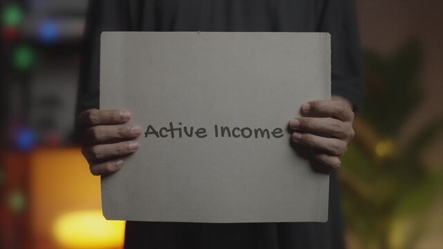 Active Income Written on Banner &ndash; Man Holding Placard