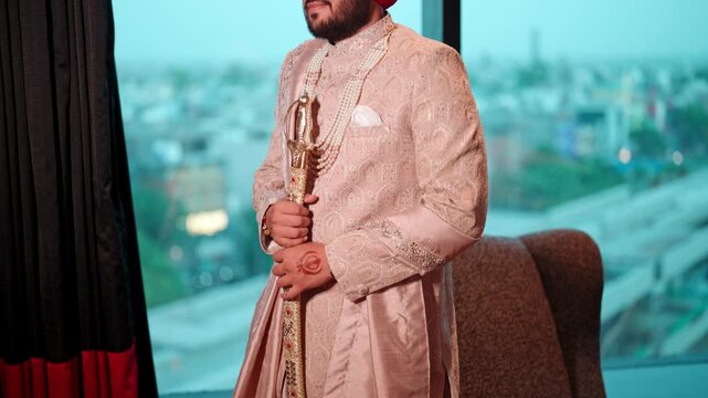 Cinematic tilt up Reveal of Sikh Groom Holding Kirpan against a Blurred City Window Background
