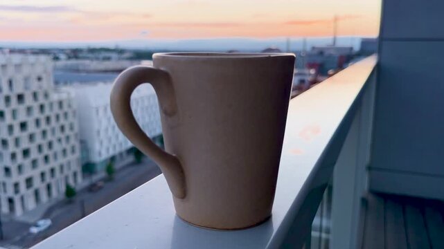 Hot drink on Terrace with Golden Sunset over J&auml;tk&auml;saari Rooftops, mid summer night sunset