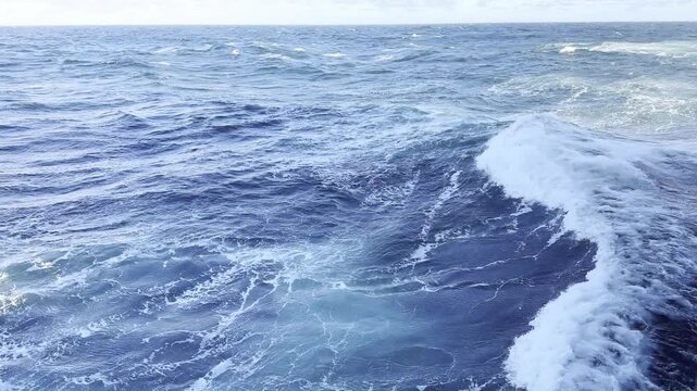 ship proceeding at ocean, cut the moderate waves and make opposite swell. bow waves of the vessel.