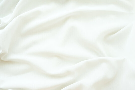 Elegant White Silk Fabric Texture Background with Soft Folds and Luxury Textile Waves