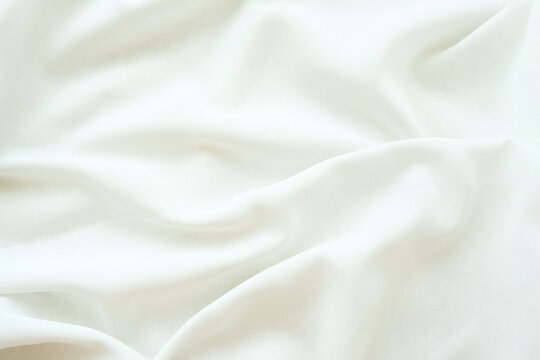 Elegant White Silk Fabric Texture Background with Soft Folds and Luxury Textile Waves