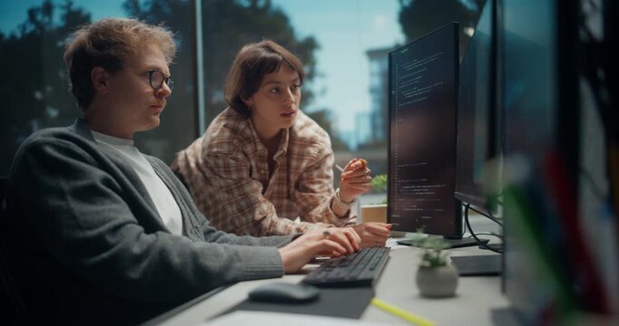 Woman Engineer Talks to Male Developer, Collaborating on Code discuss of Mobile Commerce Features, AI Models, API Optimisation and Secure Release in Modern Software Office.