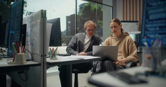 Portrait of Team of Female and Male App Engineers discuss a Laptop Prototype in a Modern Office, Ecommerce UX,  AI Personalization, Test Data and Cybersecurity Risks Modern Office