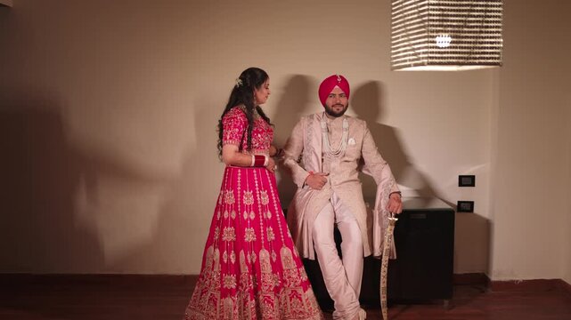 Romantic Sikh Bride And Groom Looking At Each Other in Wedding Attire