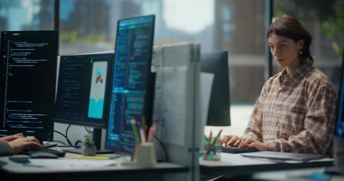 White Female and Male Software Developers Coding on Computers in Modern Office, Programming Mobile App Interface, Building Algorithms and Writing Code on Multiple Screens for Tech Startup Project