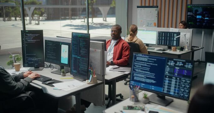 Diverse Team of Programmers Engineer Mobile App Interface Code in Modern  Tech Office. Dev Engineers Type Cybersecurity,  Analyze Data. Elevated Shot of Video Game Development Company