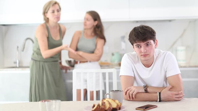 Upset guy dont speaking after discord with mother and young wife standing behind