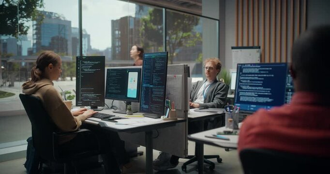  Using Working Computer. Young Multicultural Software Development Team App in a Modern Office: Woman Types Frontend Code, Male Optimizes Ui Design, Specialist Reviews Cybersecurity Scripts.