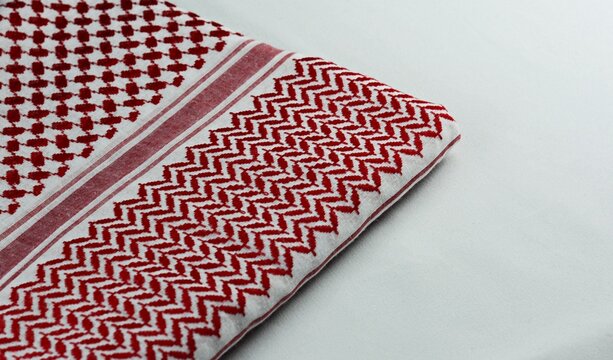 Traditional red and white Arabic folded shemagh fabric background