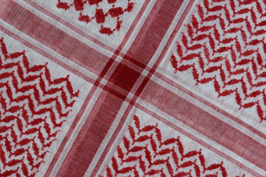 Traditional red and white Arabic folded shemagh fabric background