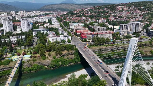 Aerial drone view of the capital city Podgorica in Montenegro, with the bell towers of the Orthodox Temple of Christ's Resurrection and the Millennium Bridge. Architecture of a Balkan city in Europe.