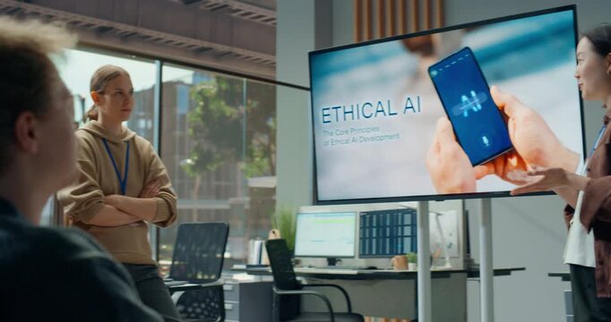 Office Presentation Meeting: Office Presentation Meeting: Woman Speaker Outlines Ethical Ai App Concept on Large Screen as Diverse Software Developer Team Listens, Debates Coding, Cybersecurity and UI