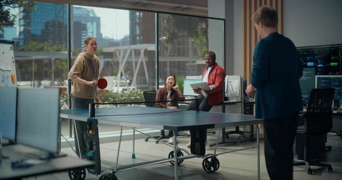 Female and Male Programmers Enjoy a Table Tennis Game While a Black Male Engineer and Female Designer Brainstorm App Development, Coding, Ux Design, Typing Workflow and Cybersecurity in Modern Office